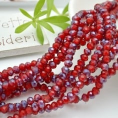 Filo rondelle briolette in mezzi cristalli rosso viola 3 x 4 mm 120pz Gioie d'Oriente