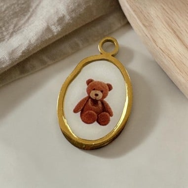 Ciondolo ovale con stampa di Orsetto in Acciaio oro 13x21mm 1pz | GDO